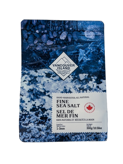 A package of Vancouver Island Fine Sea Salt, 300g bag, with a predominantly blue design featuring images of salt crystals and ocean waves.